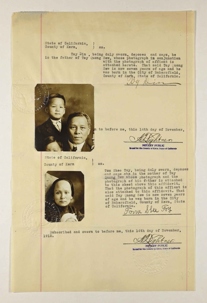 This document is a typed, notarized affidavit from the State of California, County of Kern, dated November 14, 1912. It contains sworn statements by Toy Din and Tom Shee Toy affirming the parentage and birthplace of their son, Toy Quong Sew.The upper portion of the document reads: “State of California, County of Kern, ss. Toy Din, being duly sworn, deposes and says, he is the father of Toy Quong Sew, whose photograph in conjunction with the photograph of affiant is attached hereto. That said Toy Quong Sew is now seven years of age and he was born in the City of Bakersfield, County of Kern, State of California.” The statement is signed “Toy Din” and notarized, with a visible notary public stamp and signature reading “A. Lightner, Notary Public, in and for the County of Kern, State of California.” The notarial text states the affidavit was subscribed and sworn to on the 14th day of November. Affixed below this statement is a sepia-toned portrait photograph showing an adult man (presumably Toy Din) and a young boy (Toy Quong Sew). The boy appears formally dressed in a suit jacket; the man wears a dark coat and tie. A faint embossed seal overlaps part of the photograph. The lower portion of the page contains a second sworn statement: “State of California, County of Kern, ss. Tom Shee Toy, being duly sworn, deposes and says she is the mother of Toy Quong Sew whose photograph and the photograph of his father is attached to this sheet above this affidavit. That the photograph of this affiant is also attached to this affidavit. That said Toy Quong Sew is now seven years of age and he was born in the City of Bakersfield, County of Kern, State of California.” This statement is signed “Tom Shee Toy” and similarly notarized by A. Lightner on November 14, 1912. A second sepia portrait photograph is attached near this statement, depicting a woman (Tom Shee Toy) holding a young child. An embossed seal is partially visible near this photograph as well. The document combines typed legal text, handwritten signatures, attached photographs, embossed official seals, and notary stamps. It appears to have been created to formally document and verify the birth and parentage of Toy Quong Sew in Bakersfield, California. Physical Details Typed legal affidavit on cream paper with red vertical margin lines. Two attached sepia portrait photographs with embossed seals. Handwritten signatures and blue notary stamps. Page shows minor edge wear consistent with archival document handling.